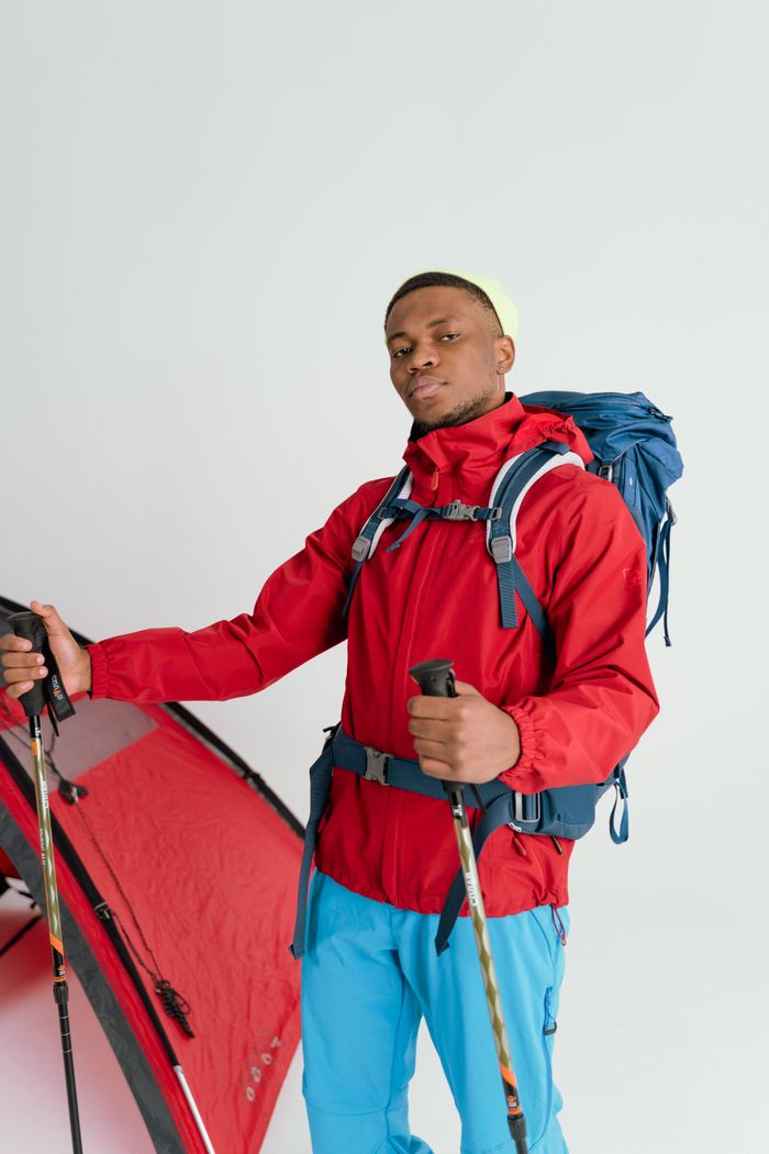 Crafting Captivating Headlines: Your awesome post title goes here Portrait of a hiker in a red jacket with tent and trekking poles.