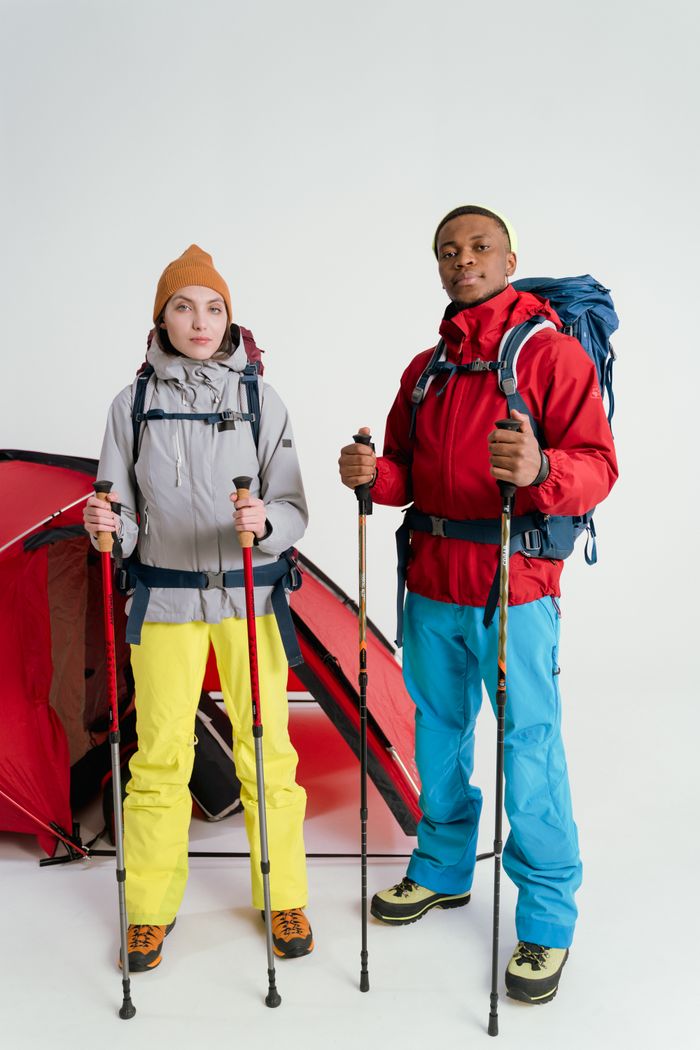 Home Two hikers with backpacks and trekking poles ready for outdoor adventure.